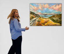 "A New Dawn," a radiant landscape print in bold colors, symbolizes new beginnings; available as a limited edition of 21 pieces.