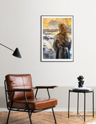 Painting of a woman seen from behind, standing before a stormy sea. The figure wears a dark cloak, hair loosely gathered. The water churns in whites and blues, while the sky glows in warm gold and grey. Work on paper by Ingela Johansson.  Set in an interior