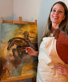 Finiished horse painting with a woman with a bow and arrow next to artist Ingela Johansson
