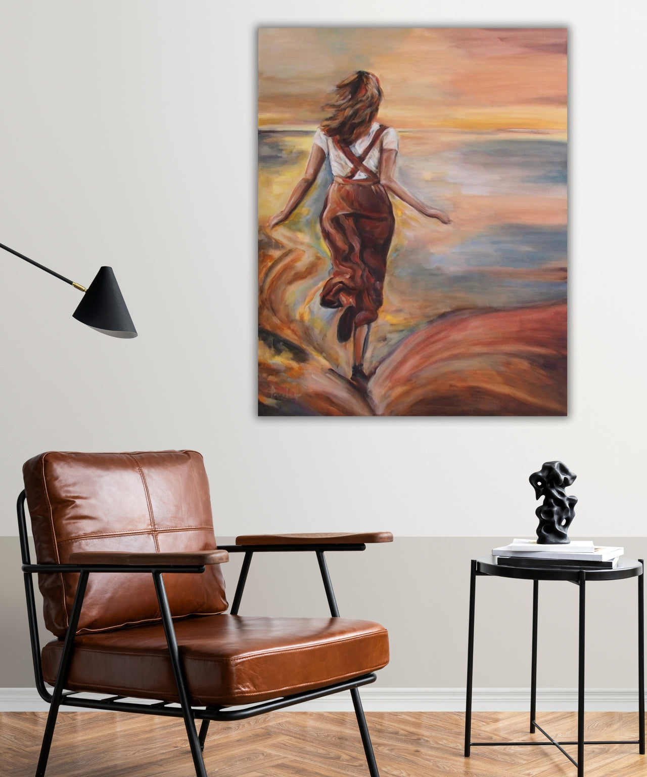 “Leap of Light” hanging above a minimalist Scandinavian sofa. The painting’s warm yellow tones add energy to the neutral-toned living space.