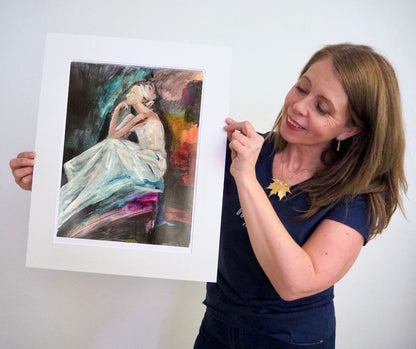 Artist Ingela Johansson with a print of Thinker 