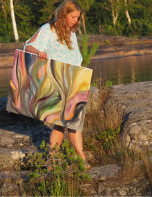 Artist Ingela Johansson with her painting Sunset Currents at the location where it was painted, by the water