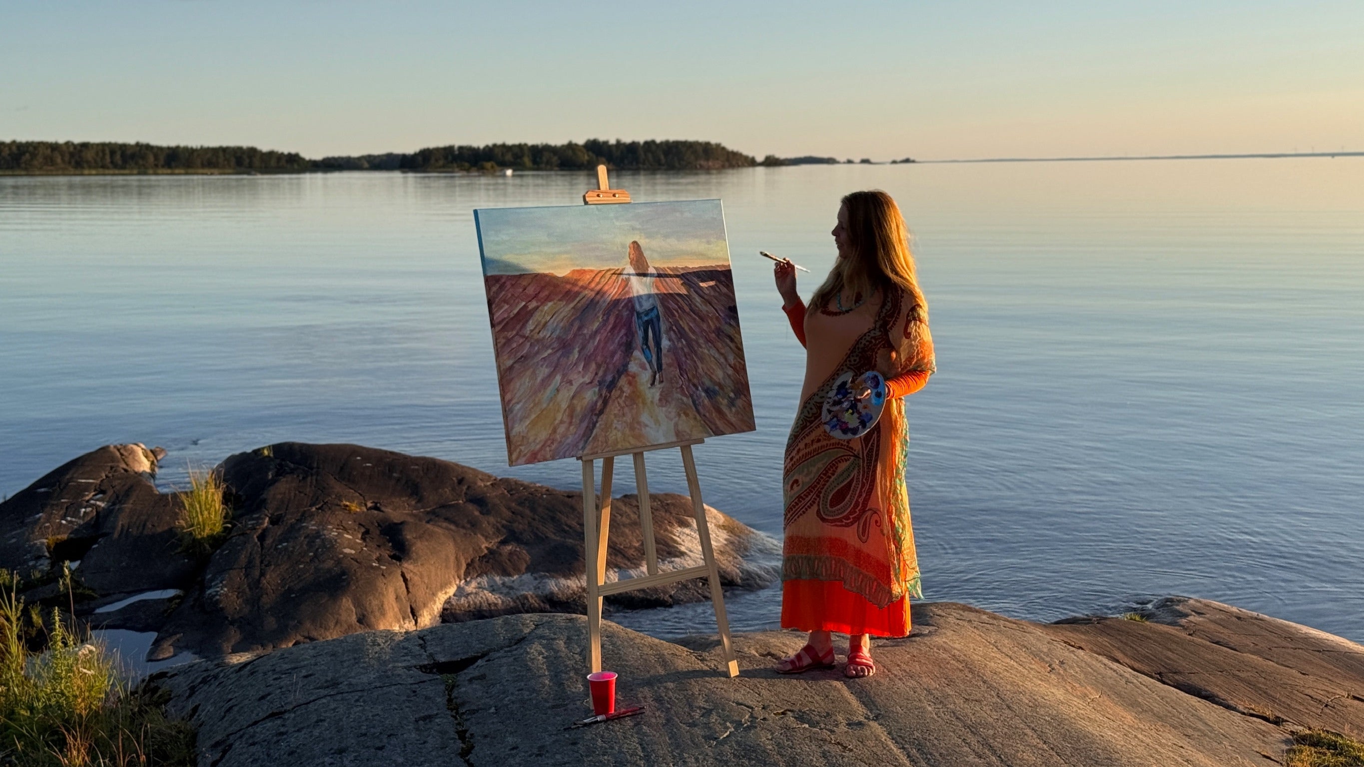 artist ingela johansson painting at lake vänern summer studio