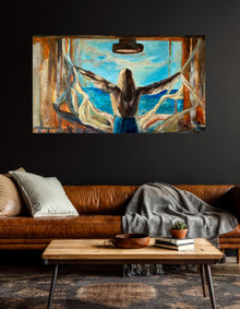 Open Up, an original acrylic painting by Swedish artist Ingela Johansson, shown in a living room — a woman seen from behind with arms outstretched, pulling open curtains to a turquoise sea, a story about a sense of freedom.